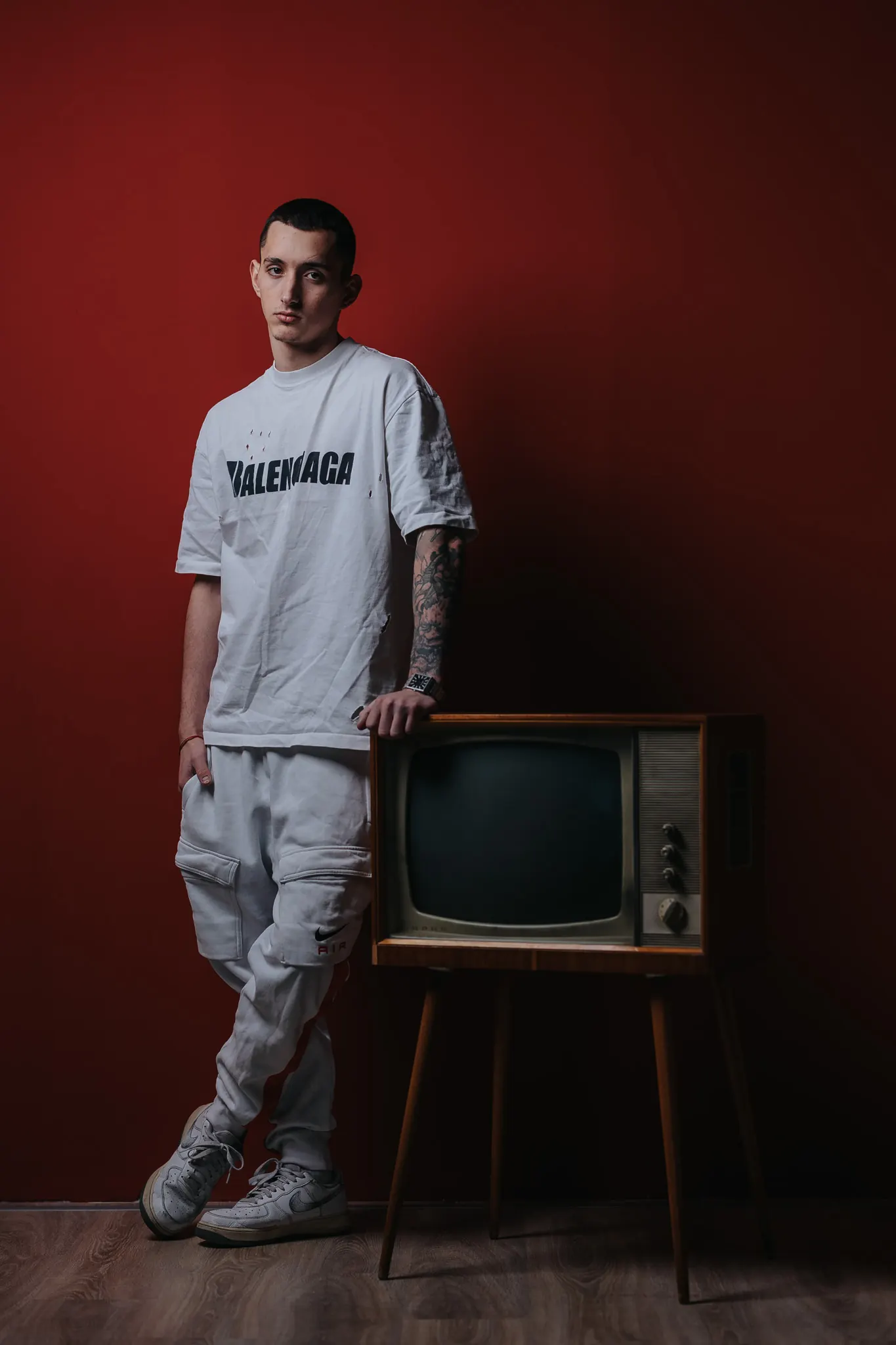 Mindslash beside a vintage TV against a red wall