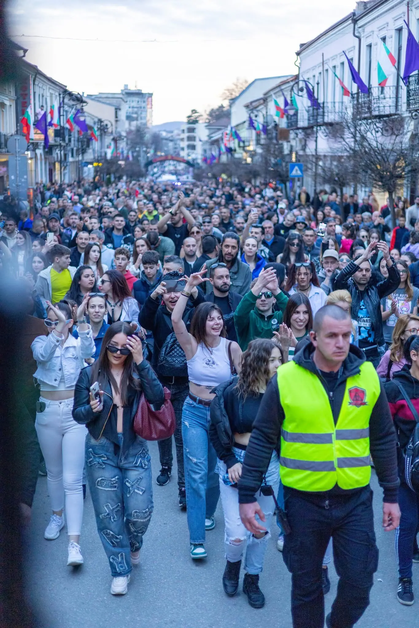 A large crowd marching through a city street
