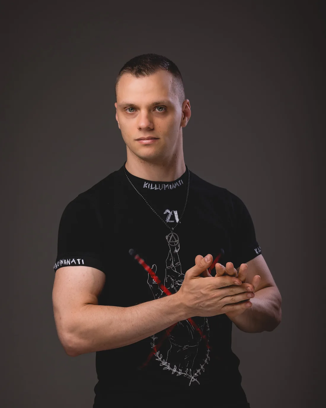 Shadowmaw with his hands together in a black T-shirt